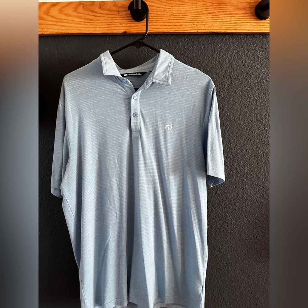 Travis Mathew’s  Light Blue Polo Shirt